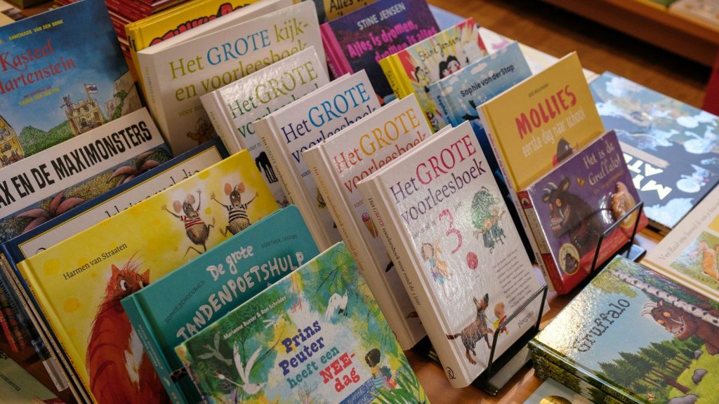 A display of colorful children's books arranged on shelves inside a bookstore.