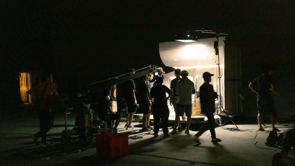 Film crew works on a television set during the final stages of a production shoot.