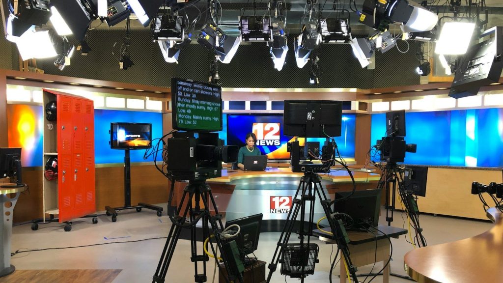 Television studio with cameras and broadcast equipment.