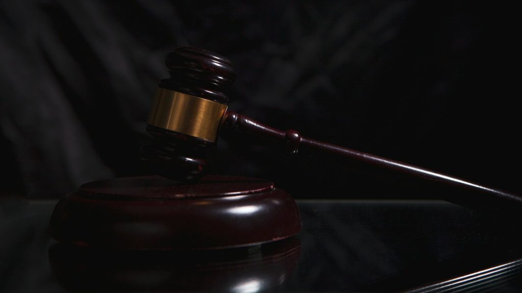 Judge's gavel on a courtroom bench