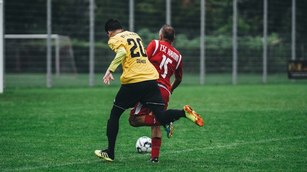 Two soccer players battling for possession during a match.