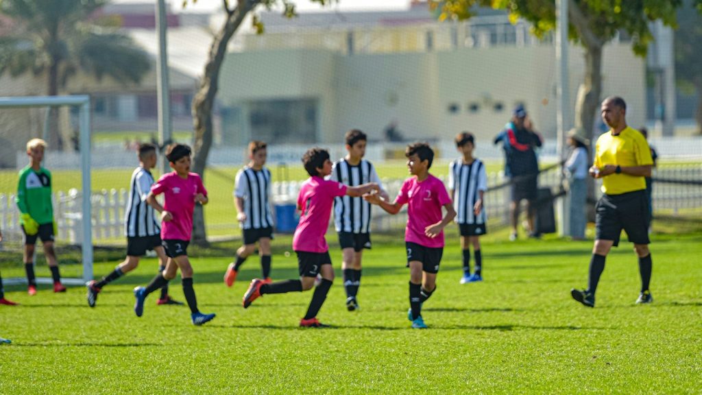 Young soccer teams compete during a match.