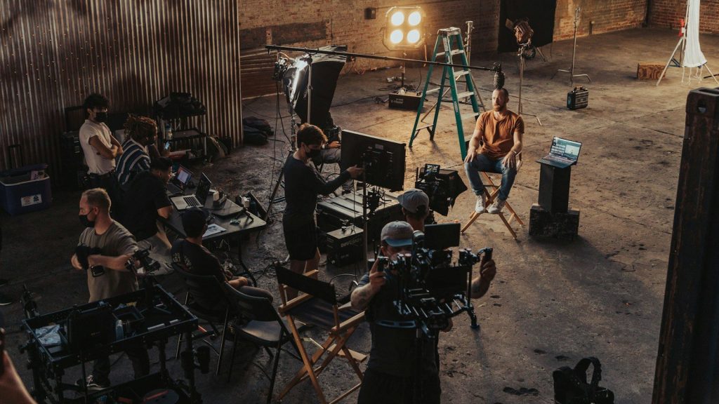 Production crew filming on a studio set.